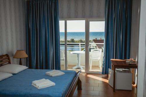 a bedroom with a bed and a view of the ocean at Villa Santorini in Zatoka