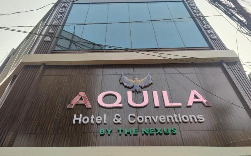 a hotel and conventions sign on the side of a building at Aquila Hotel and Convention by The Nexus in Patna