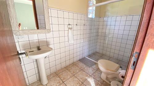 a bathroom with a toilet and a sink at Pousada Montemar in Ilhabela