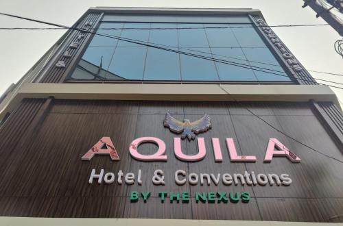 a hotel and conventions sign on the side of a building at Aquila Hotel and Convention by The Nexus in Patna