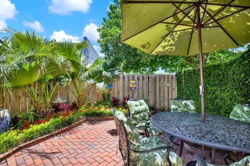 a patio with a table with an umbrella and chairs at Jet Setter in Savannah