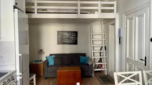 a living room with a couch and a loft bed at Lägenhet med 6 sovplatser i centrala Göteborg! in Gothenburg