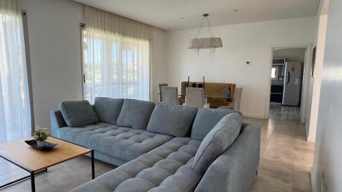 a living room with a blue couch and a table at MC Ceibos in Belén de Escobar