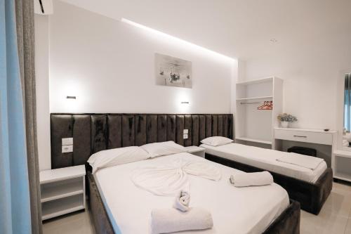 two beds in a room with two beds sidx sidx sidx sidx at Vila ZOGAJ in Ksamil