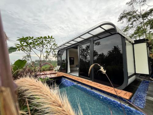 a house with a swimming pool next to a house at Nira Cangkringan Akasha in Bedoyo