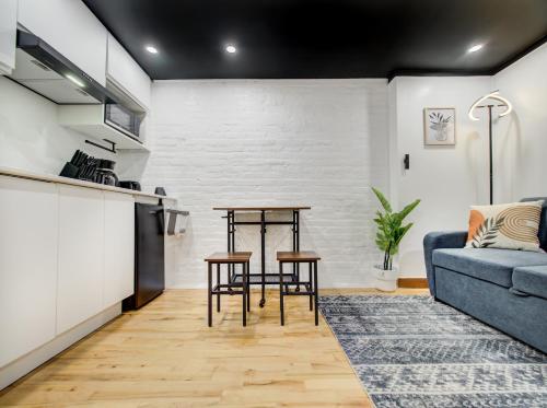 a living room with a blue couch and a table at Stylish-24 1-Bedroom in HoMa Montreal in Montréal