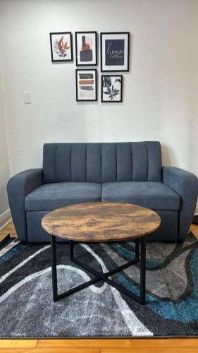 a living room with a blue couch and a coffee table at Spacious 4-Bedrooms in HoMa Montreal 22 in Montréal