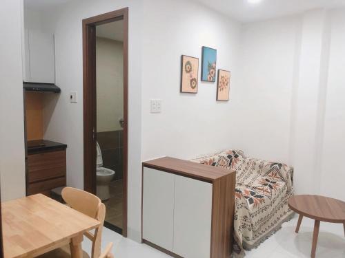 a living room with a chair and a table at CH Home in Danang