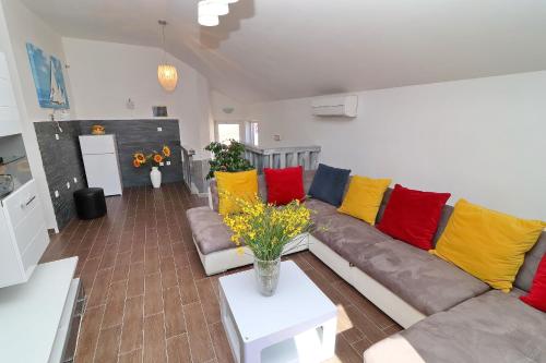 a living room with a couch with colorful pillows at Villa Mila in Vela Luka