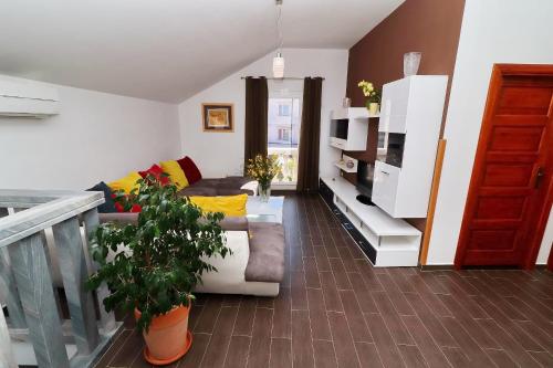 a living room with a couch and a tv at Villa Mila in Vela Luka