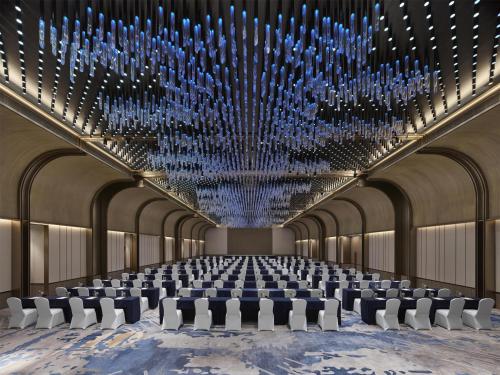 a large room with chairs and a large chandelier at Hilton Shanghai Greater Hongqiao in Shanghai