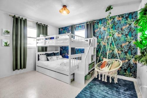 a bedroom with a white bunk bed and a swing at Madeira Beach Family & Pet Friendly Luxury Getaway in Seminole