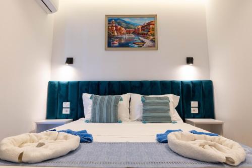 a bedroom with a bed with two towels on it at Vila ZOGAJ in Ksamil