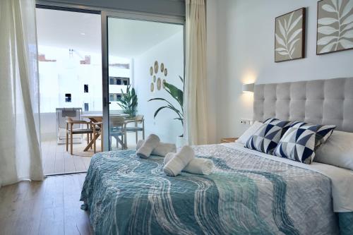 a bedroom with a bed with two towels on it at Mar de Fabiola Apartamentos Playa Granada in Motril