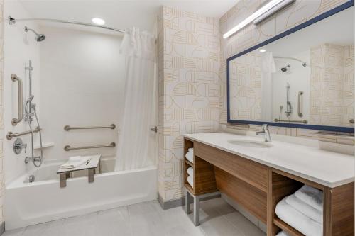 a bathroom with a sink and a tub and a shower at Home2 Suites By Hilton Bozeman Four Corners in Bozeman