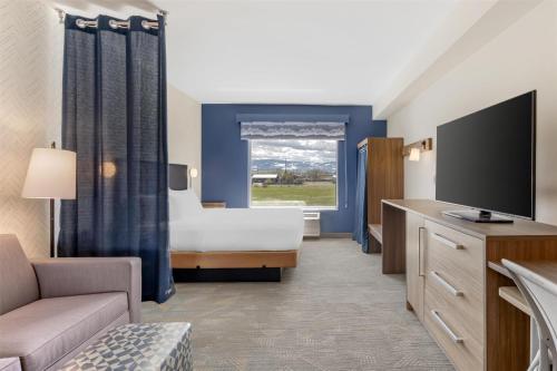 a hotel room with a bed and a television at Home2 Suites By Hilton Bozeman Four Corners in Bozeman