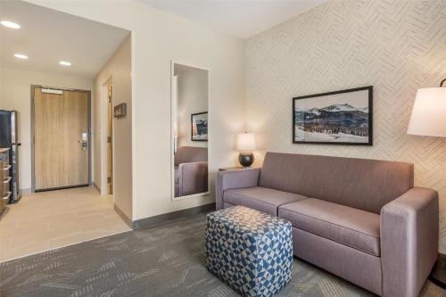 a living room with a couch and a bed at Home2 Suites By Hilton Bozeman Four Corners in Bozeman