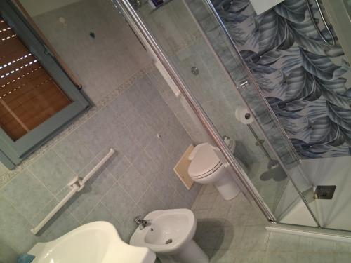 a bathroom with a shower and a toilet and a sink at Casa stella marina Villasimius.. in Villasimius