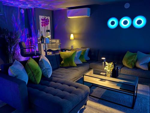a living room with a couch and a table at Sunridge Fishing Lodge with Hot Tub & Giant Cinema in Plymouth