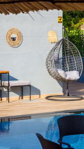 a swing sitting next to a swimming pool at Vila ZOGAJ in Ksamil