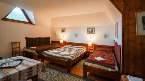 a living room with two beds and a couch at Gyimesi Skanzen in Valea Boroş