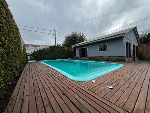 a large swimming pool on a wooden deck at Tu hogar para vacacionar in Mar del Plata
