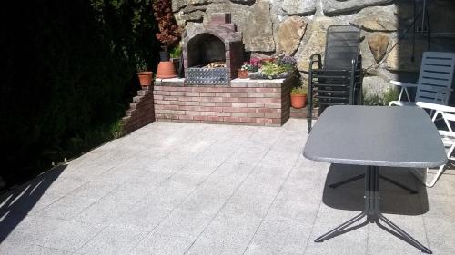 a table and chairs on a patio with an outdoor oven at Haus Franziska in Kappl