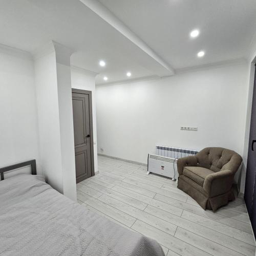 a bedroom with a bed and a chair at Casablanca in Kaji-Say