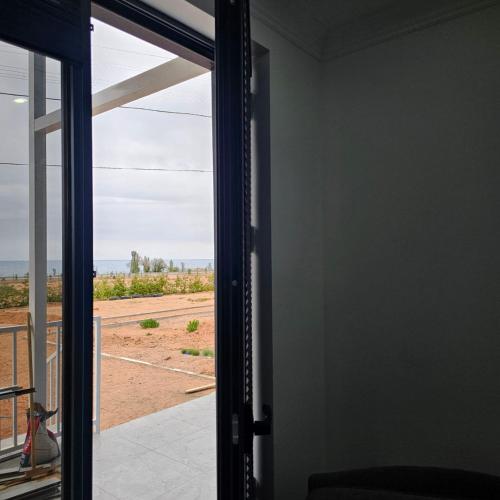an open door with a view of a field at Casablanca in Kaji-Say