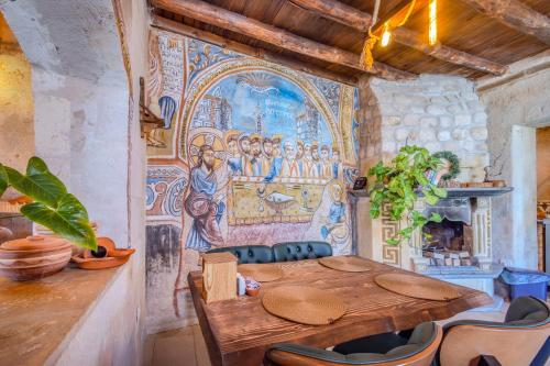 a dining room with a table and a mural on the wall at Onur Cave Cappadocia in Goreme