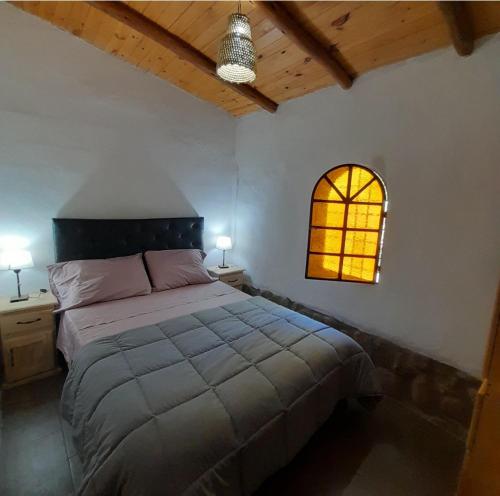 Postel nebo postele na pokoji v ubytování ENRAMADA Hospedaje en San Marcos Sierras