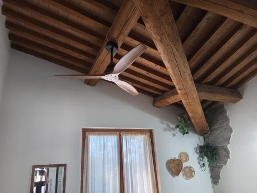 a ceiling fan in a room with a window at I TRE POETI in Saturnia