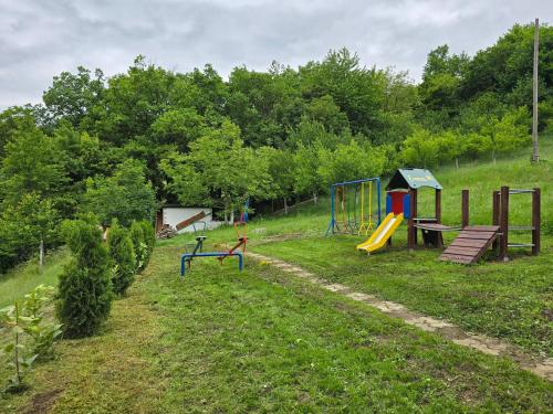 a park with a playground and a play area at Guest House Queen in Konjic