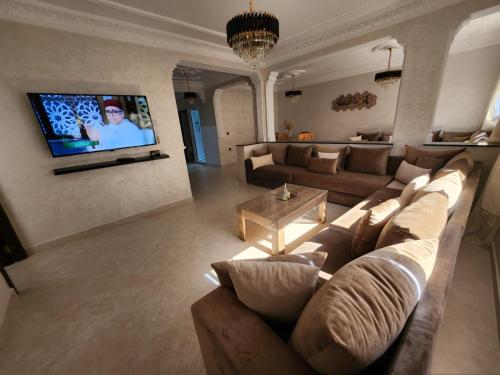 a living room with a couch and a tv at Holiday dream of Martil 2 in Martil