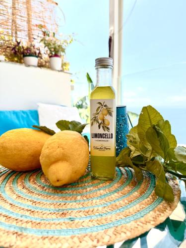 a bottle of immunity liquid next to two oranges at Wonderhome Praiano in Praiano