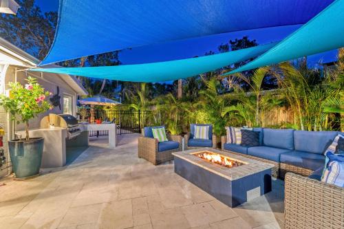 a patio with couches and a fire pit at Beach Palm Villa - 5533 in Siesta Key