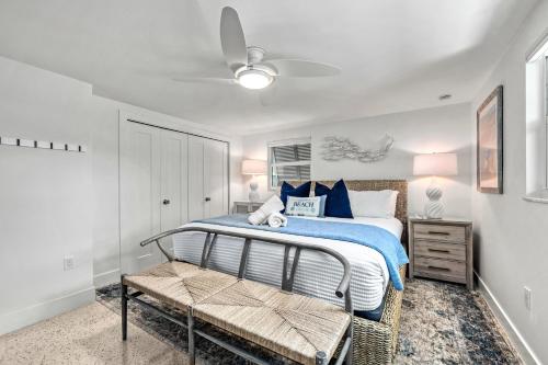 a bedroom with a bed with a blue blanket at Beach Palm Villa - 5533 in Siesta Key