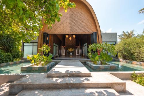 an external view of a building with a pool at Ananea Madivaru Maldives in Toroka