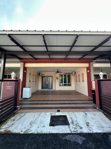 a view of a building with an open garage at Ahnaf Guesthouse in Sitiawan