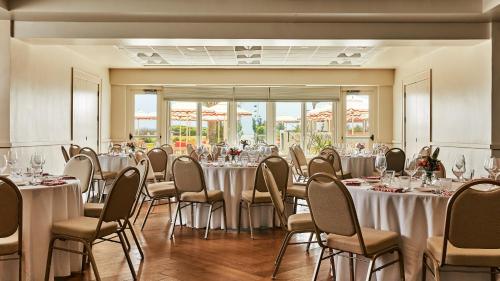 a banquet room with tables and chairs with white tablecloths at Trailborn Surf & Sound, Outdoor Collection by Marriott Bonvoy in Wrightsville Beach