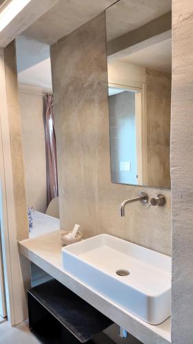 a bathroom with a white sink and a mirror at Borgo del Lago in San Gemini