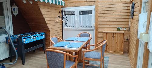 a small kitchen with a table and chairs in a room at Ferienhaus Stamer am großen Meer in Bedekaspel