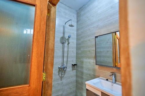a bathroom with a shower and a sink at Favourites home in Arusha