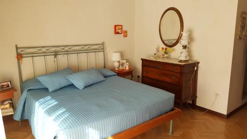 ポルト・レカナーティにあるB&B Un mare di Gioiaのベッドルーム1室(ベッド1台、鏡、ドレッサー付)