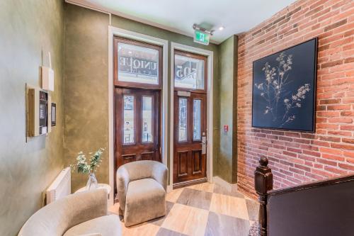 a lobby with chairs and a brick wall at Self Check-In Boutique Hotel - Quartier latin - Room 301 in Montréal