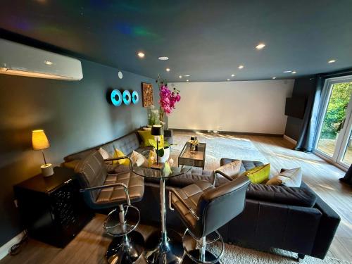a living room with a couch and a table at Sunridge Fishing Lodge with Hot Tub & Giant Cinema in Plymouth