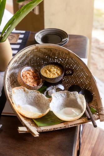 a basket with food in it on a table at Dunes Unawatuna Hotel in Unawatuna