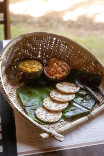 a basket with cookies and other food in it at Dunes Unawatuna Hotel in Unawatuna