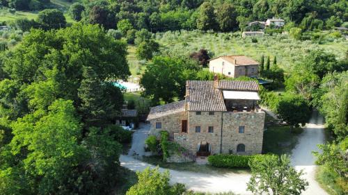 an aerial view of a stone house in a forest at Hotel Giogliano in Radicondoli