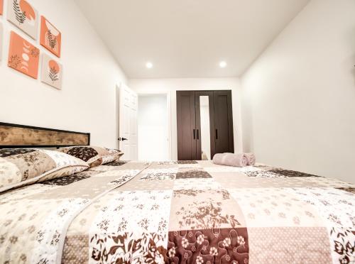a bedroom with a large bed with a quilt on it at Spacious 4-Bedrooms in HoMa Montreal 22 in Montréal